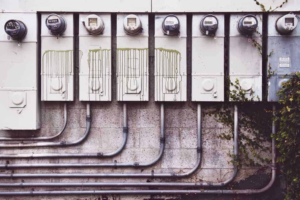 Photo of eight electricity meters mounted to a building's exterior wall