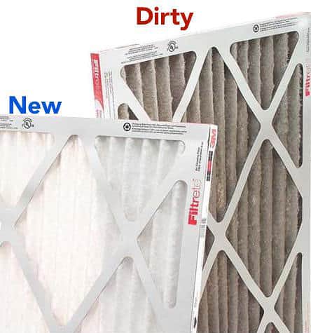 photo shows that a dirty furnace filter is brown and full of dust, next to a new furnace filter that is white and clean