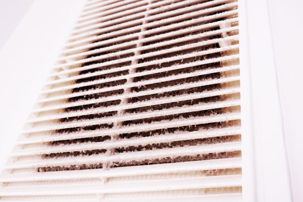 layer of dust on the outside of an air vent showing that it is time to change the commerical HVAC filter