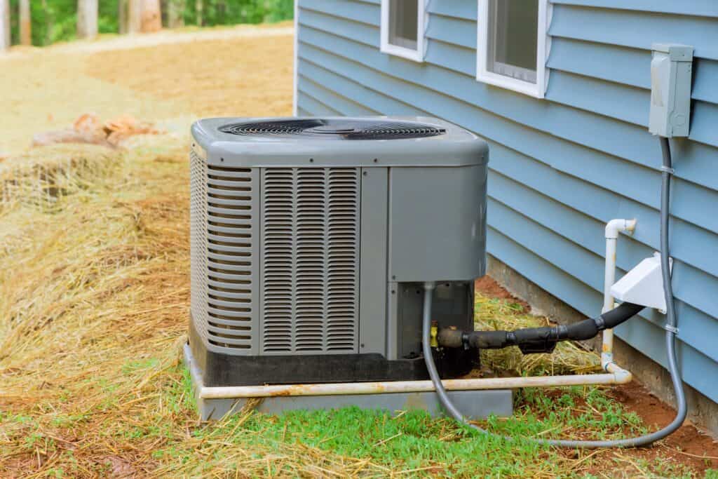 exterior of a home air conditioner unit showing the drain line
