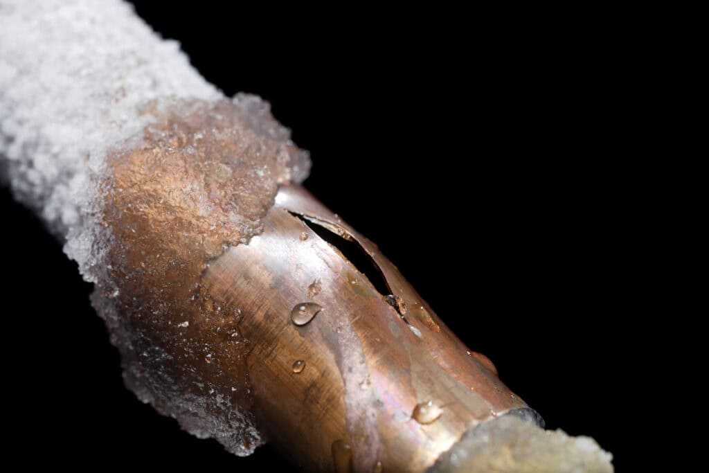 a pipe in a residential home with frost on it and a crack. how to fix frozen pipes